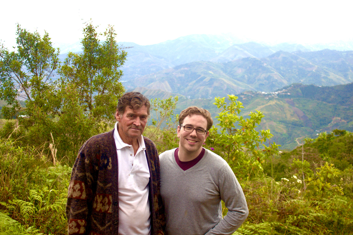 Bird and Bear founder Dan Streetman stands in a coffee field at Los Alisos farm with Peruvian coffee farmer Sergio Palermo